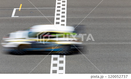 Motion blur race car racing on speed track, Car race on the international circuit race track crossing start and finish line, Race car crossing start and finish line, Target business achieve. 120052737