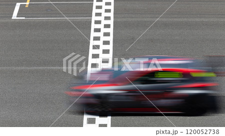Motion blur race car racing on speed track, Car race on the international circuit race track crossing start and finish line, Race car crossing start and finish line, Target business achieve. 120052738