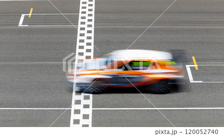 Motion blur race car racing on speed track, Car race on the international circuit race track crossing start and finish line, Race car crossing start and finish line, Target business achieve. Motion blur race car racing on speed track, Car race on the international circuit race track crossing start and finish line, Race car crossing start and finish line, Target business achieve. 120052740
