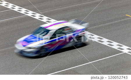 Motion blur race car racing on speed track, Car race on the international circuit race track crossing start and finish line, Race car crossing start and finish line, Target business achieve victory. 120052743