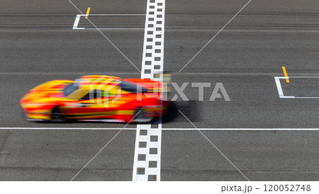 Motion blur race car racing on speed track, Car race on the international circuit race track crossing start and finish line, Race car crossing start and finish line, Target business achieve. Motion blur race car racing on speed track, Car race on the international circuit race track crossing start and finish line, Race car crossing start and finish line, Target business achieve. 120052748