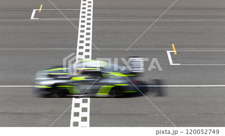 Motion blur race car racing on speed track, Car race on the international circuit race track crossing start and finish line, Race car crossing start and finish line, Target business achieve. Motion blur race car racing on speed track, Car race on the international circuit race track crossing start and finish line, Race car crossing start and finish line, Target business achieve. 120052749