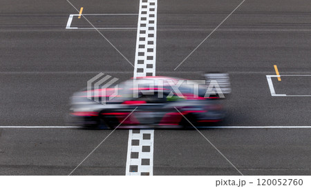 Motion blur race car racing on speed track, Car race on the international circuit race track crossing start and finish line, Race car crossing start and finish line, Target business achieve. 120052760