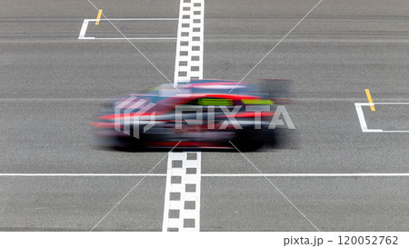 Motion blur race car racing on speed track, Car race on the international circuit race track crossing start and finish line, Race car crossing start and finish line, Target business achieve. Motion blur race car racing on speed track, Car race on the international circuit race track crossing start and finish line, Race car crossing start and finish line, Target business achieve. 120052762