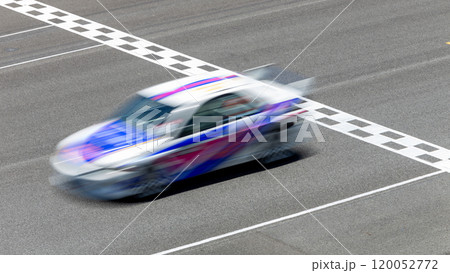 Motion blur race car racing on speed track, Car race on the international circuit race track crossing start and finish line, Race car crossing start and finish line, Target business achieve victory. 120052772