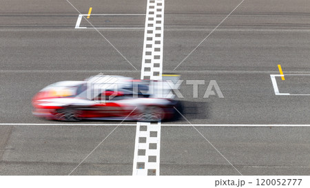 Motion blur race car racing on speed track, Car race on the international circuit race track crossing start and finish line, Race car crossing start and finish line, Target business achieve. 120052777