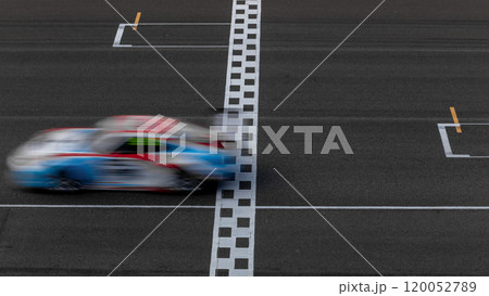 Motion blur race car racing on speed track, Car race on the international circuit race track crossing start and finish line, Race car crossing start and finish line, Target business achieve. 120052789