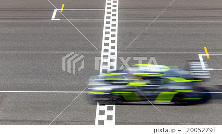 Motion blur race car racing on speed track, Car race on the international circuit race track crossing start and finish line, Race car crossing start and finish line, Target business achieve. Motion blur race car racing on speed track, Car race on the international circuit race track crossing start and finish line, Race car crossing start and finish line, Target business achieve. 120052791