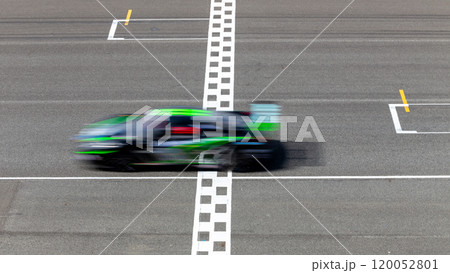 Motion blur race car racing on speed track, Car race on the international circuit race track crossing start and finish line, Race car crossing start and finish line, Target business achieve. 120052801
