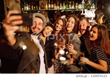 Happy friends throwing confetti, jumping while enjoying party. Confetti is fun. Party, celebration. 120054122