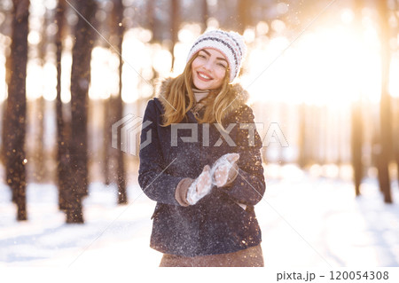 Happy woman plays with snow in sunny winter day. Girl enjoys winter, frosty day. Playing with snow. Happy woman plays with snow in sunny winter day. Girl enjoys winter, frosty day. Playing with snow. 120054308