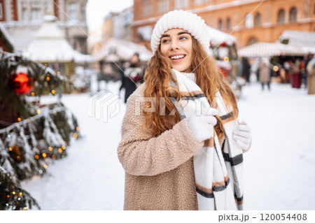 Beautiful woman on a city street during the Christmas holidays. Christmas concept, holidays. Beautiful woman on a city street during the Christmas holidays. Christmas concept, holidays. 120054408