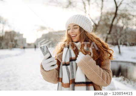 Young woman taking selfie in winter street. Holidays, rest, blogging. 120054415