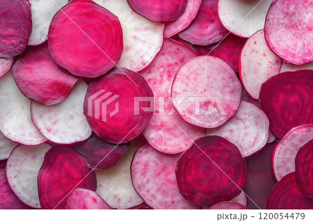 Colorful assortment of freshly cut radish slices arranged neatly on a wooden surface for a vibrant 120054479