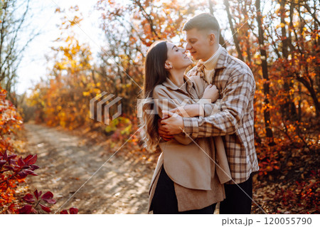 Couple in love newlyweds in casual clothes travel together, hike and walk in autumn forest in nature Couple in love newlyweds in casual clothes travel together, hike and walk in autumn forest in nature 120055790