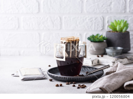 Freshly brewed drip coffee in glass cup 120056804