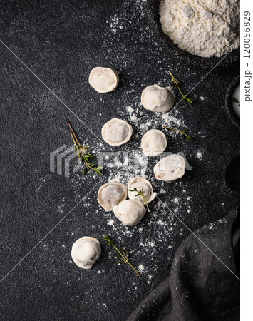 Raw dumplings or ravioli on black background 120056829
