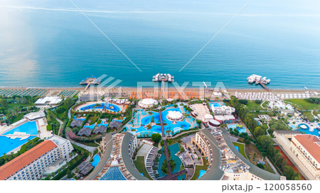 Aerial view of a luxurious seaside resort with multiple pools, scenic beach access, and breathtaking ocean views for an unforgettable vacation experience. Aerial view of a luxurious seaside resort with multiple pools, scenic beach access, and breathtaking ocean views for an unforgettable vacation experience. 120058560