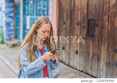 Female tourist walks through the colonial streets San Cristobal de las Casas, Mexico. Cultural exploration, architecture, and travel experience concept 120059340