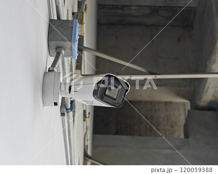 Security cameras installed to ensure safety, set against a wall in the building. 120059388