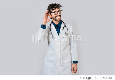Smiling doctor listening to a rumor. Young doctor smiling with hand over ear isolated, Smiling doctor extending hand isolated 120060018