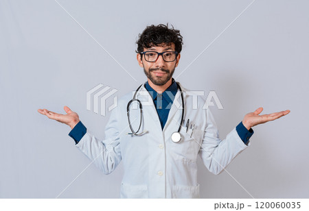 Doctor presenting something with both palms. Young doctor with palms open to the sides. Bearded doctor with both palms open Doctor presenting something with both palms. Young doctor with palms open to the sides. Bearded doctor with both palms open 120060035