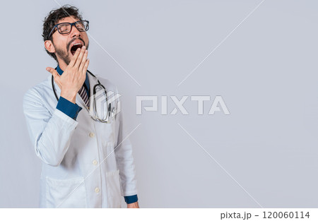Young sleepy doctor yawning on isolated background. Tired of working doctor concept, Tired and sleepy doctor isolated 120060114