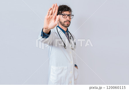 Serious doctor making stop gesture on isolated background, Young doctor making stop gesture with palm of hand 120060115
