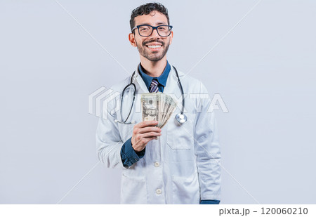 Happy young doctor holding money isolated. Handsome doctor showing money on white background Happy young doctor holding money isolated. Handsome doctor showing money on white background 120060210