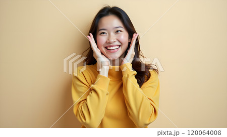 Asian Woman Happily Pointing to Upper Side with Both Fingers in Studio 120064008