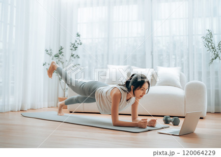 Young Asian woman in sportswear doing plank on training mat 120064229