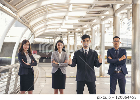 Portrait Group of businesspeople arms crossed smiling look at camera in modern city background. Happy Businessman, businesswoman teams partnership. Business people teams positive teamwork standing. 120064455