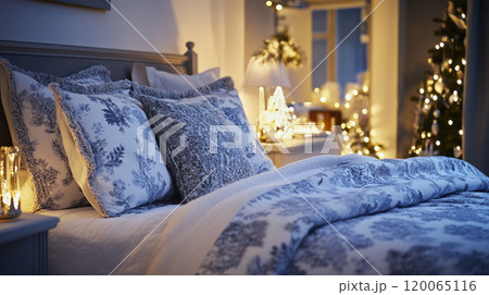 Bed and pillows in bedroom with Christmas tree and holiday decorations 120065116
