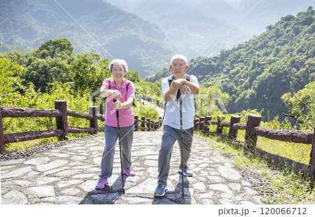 Happy asian senior couple hiking in the nature 120066712
