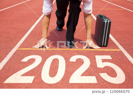 Happy new year 2025 concept. Business Man preparing to run on athletics track engraved with the year 2025. Getting ready for the new year 120066870