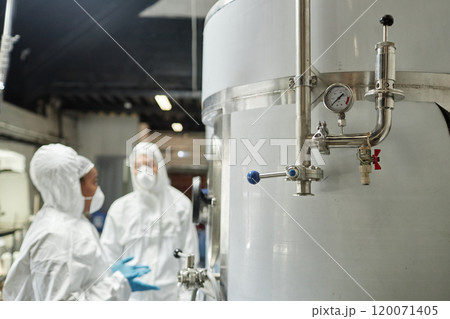 Close up on pressure gauge and pipes on stainless steel tank in workshop of food or chemical factory, copy space Close up on pressure gauge and pipes on stainless steel tank in workshop of food or chemical factory, copy space 120071405
