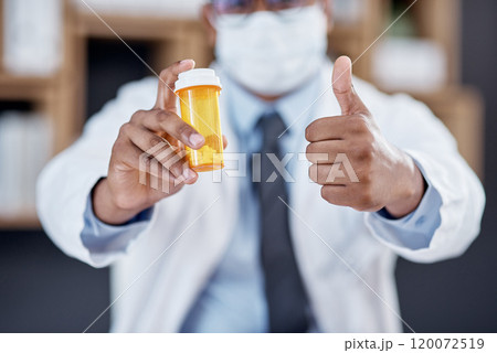 I guarantee this will work. Closeup shot of an unrecognisable doctor holding a bottle of pills and showing thumbs up in his office. 120072519