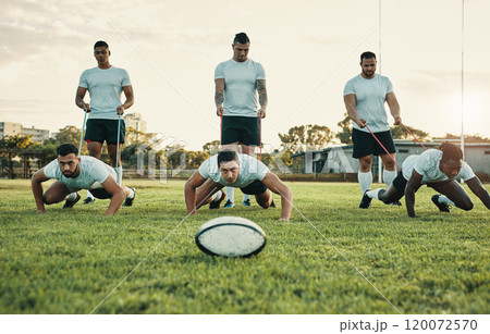 The ball is there, it takes willpower to reach it. Cropped shot of a group of young rugby players training with bands on the field during the day. 120072570