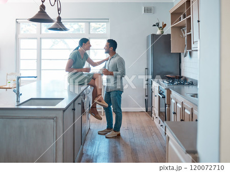 Romance, kitchen and couple with coffee, smile and bonding in weekend, morning and conversation in home. Happy, man and affection for woman, talking and love in relationship, date and break in house 120072710