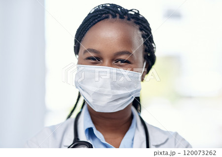 Serving on the frontlines. Portrait of a young doctor wearing a face mask while working in a hospital. 120073262