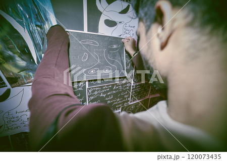 Drawing, paranoid and man in bedroom, fear and scared with mental health, depression and stress. Person, sketch and guy with pictures, OCD or creative for anxiety, psychology or bipolar with insomnia 120073435