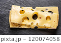 macro photo of sliced cheese with holes on stone surface top view 120074058