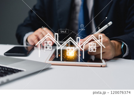 Businessman using tablet with holographic real estate icons, representing property sales and investments. Ideal for real estate, finance, digital technology themes. 120076374