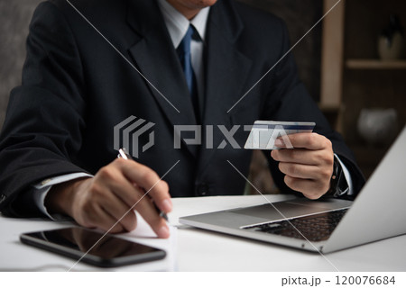 Businessman using a credit card to make an online payment, symbolizing secure digital transactions. Great for e-commerce, fintech services, or online banking Businessman using a credit card to make an online payment, symbolizing secure digital transactions. Great for e-commerce, fintech services, or online banking 120076684