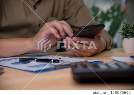 Businessperson using a smartphone for mobile banking, representing modern financial management. Suitable for fintech apps, mobile banking promotions, or finance technology Businessperson using a smartphone for mobile banking, representing modern financial management. Suitable for fintech apps, mobile banking promotions, or finance technology 120076696