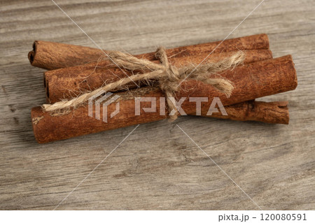 Cinnamon sticks on a wooden background 120080591