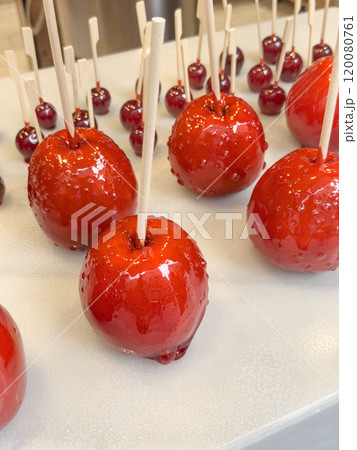 apple and cherry coated with red caramel candy apple and cherry coated with red caramel candy 120080761