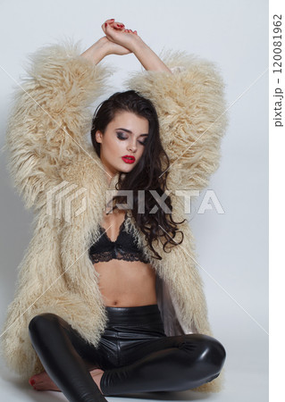 Charming fashion model woman with make-up wearing white faux fur coat posing  120081962