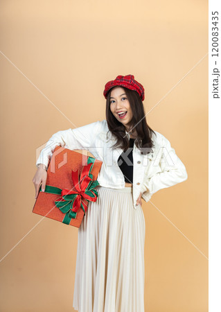 Young Asian Woman with Red Holiday Gifts Expressing Surprise and Joy During Christmas Season Shopping Experience in Studio Perfect for Seasonal Marketing Young Asian Woman with Red Holiday Gifts Expressing Surprise and Joy During Christmas Season Shopping Experience in Studio Perfect for Seasonal Marketing 120083435