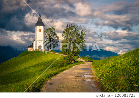 Narrow rural road and Saint Primoz mountain church, Jamnik, Slovenia 120083723